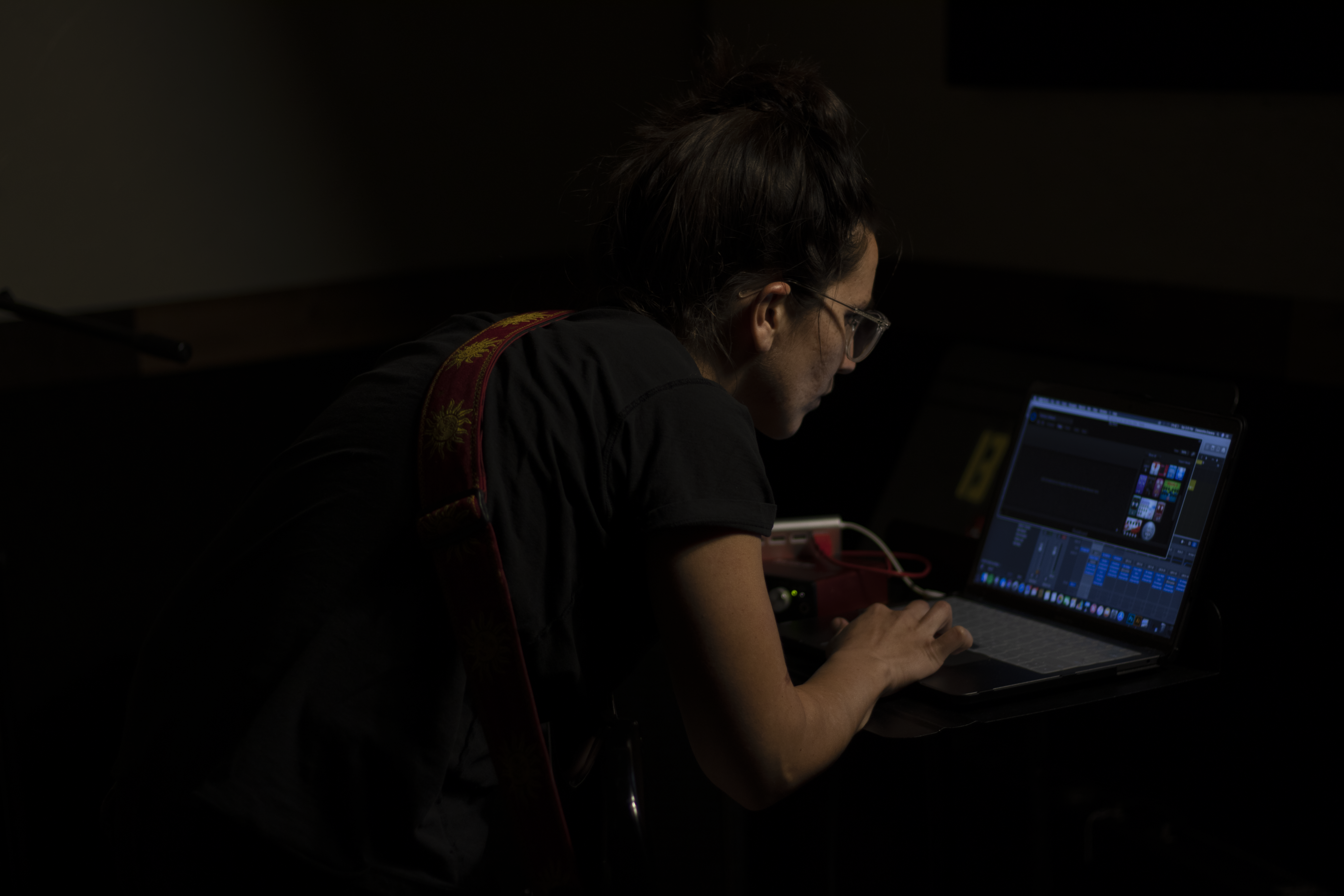 woman at computer in dark room